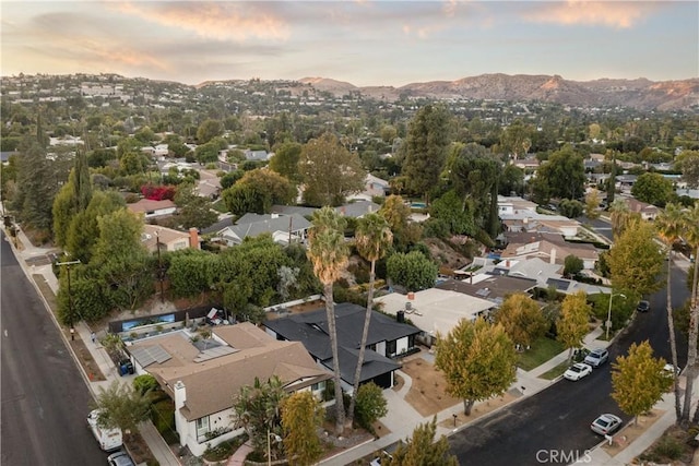 aerial view at dusk featuring a mountain view