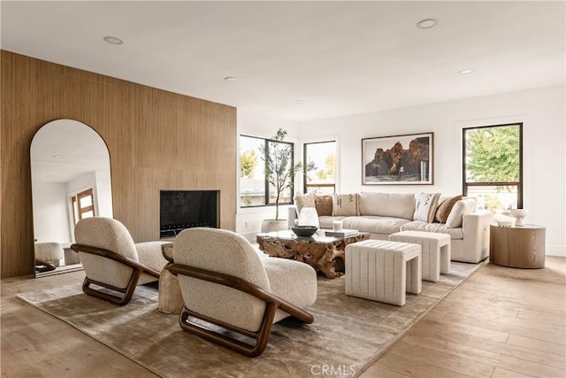 living room with light wood-type flooring and a large fireplace