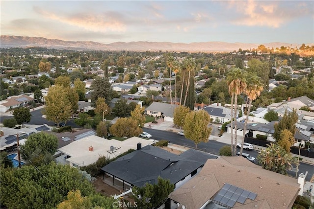 aerial view at dusk featuring a mountain view