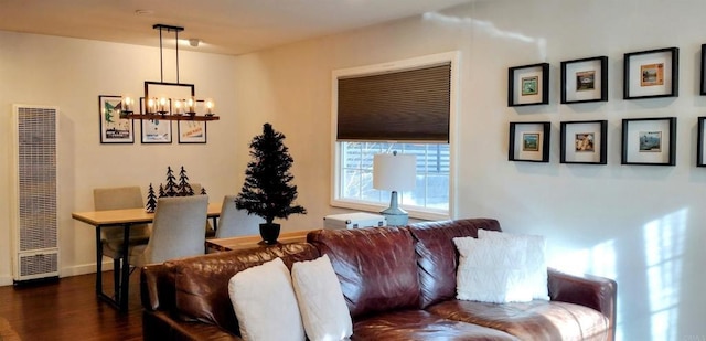 living room with dark hardwood / wood-style floors and a chandelier