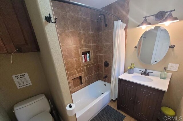 full bathroom with toilet, vanity, and shower / tub combo with curtain