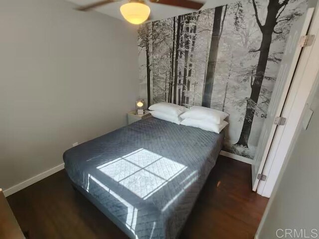 bedroom featuring ceiling fan and dark hardwood / wood-style flooring