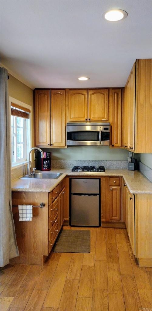 kitchen featuring sink, stainless steel appliances, and light wood-type flooring