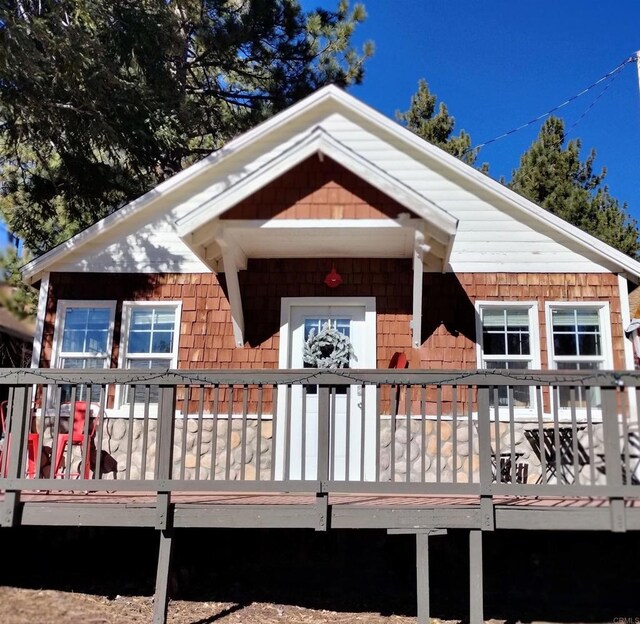 back of house featuring a wooden deck