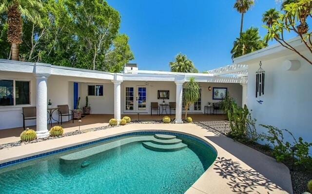 back of property featuring a pergola and a patio