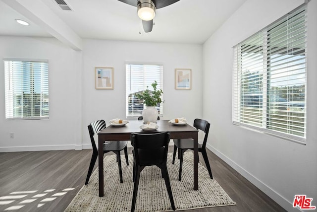 dining space with dark wood-type flooring and ceiling fan