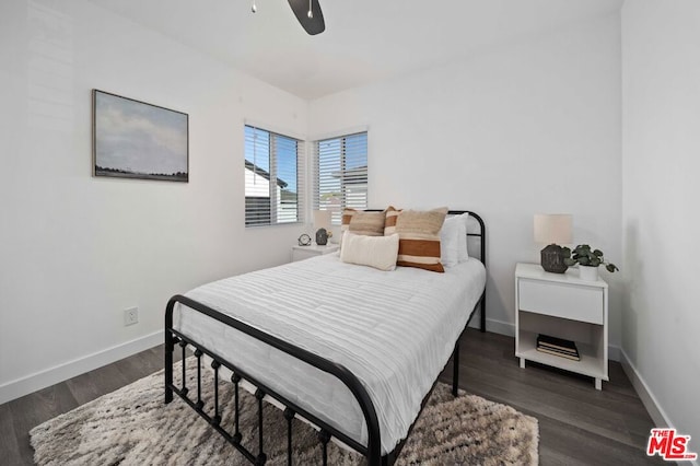 bedroom with ceiling fan and dark wood-type flooring