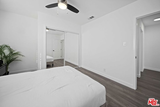 bedroom featuring ceiling fan, a closet, and dark hardwood / wood-style flooring