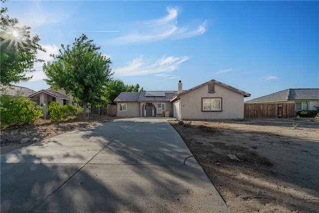 ranch-style house featuring solar panels