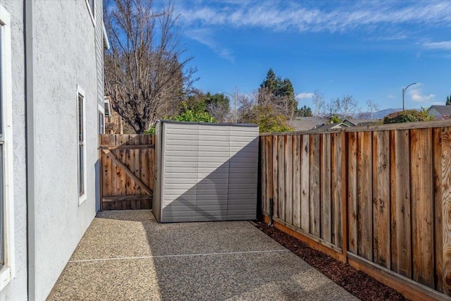 view of gate with a patio