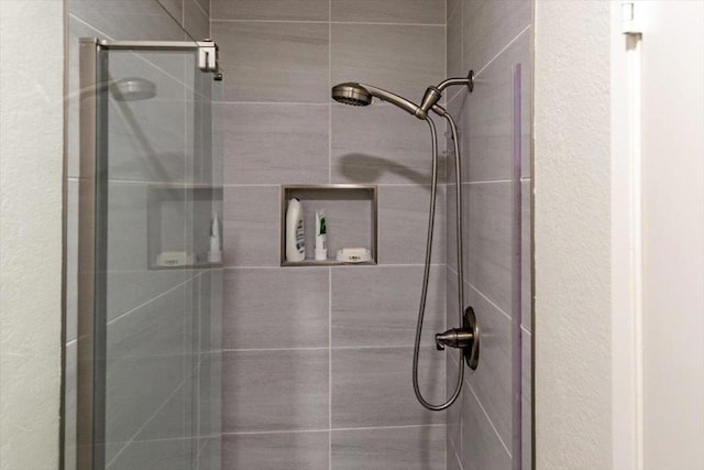 bathroom with a tile shower