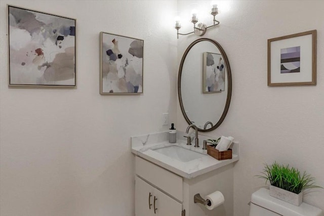 bathroom featuring toilet and vanity