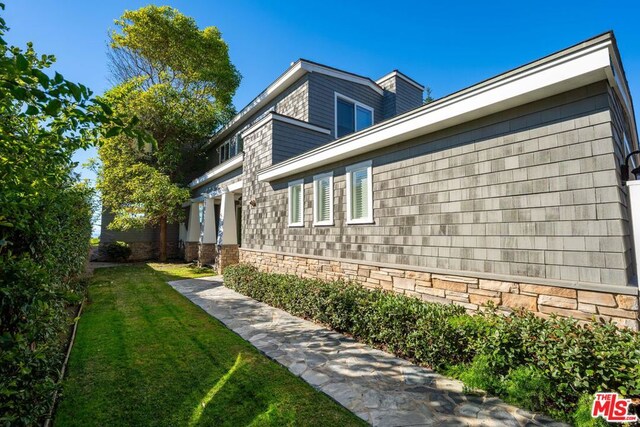 view of side of property with a yard