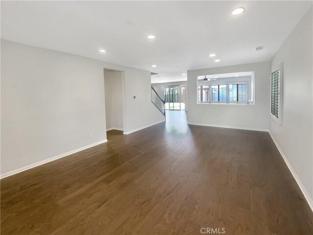 unfurnished room featuring ceiling fan and dark hardwood / wood-style floors