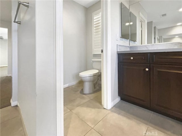 bathroom with vanity, tile patterned floors, and toilet