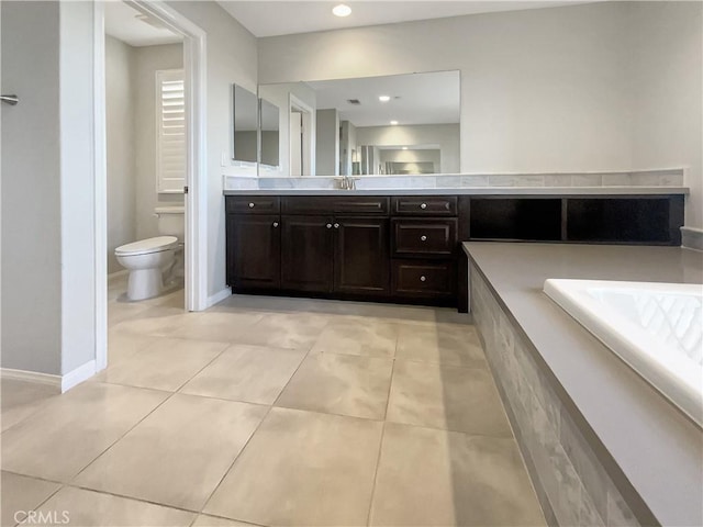 bathroom with tile patterned flooring, vanity, and toilet