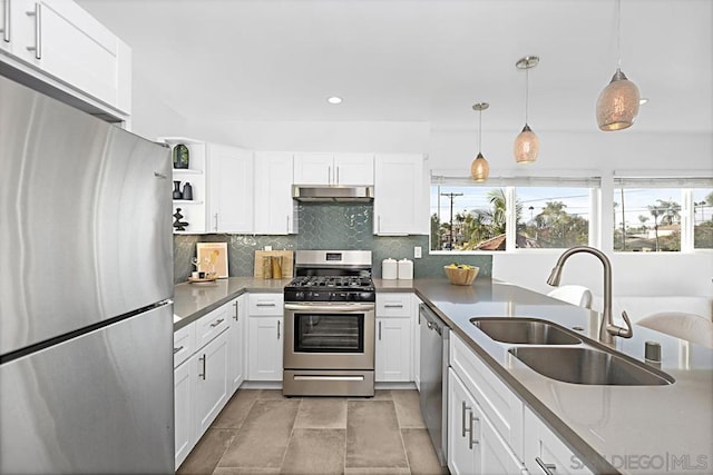 kitchen featuring sink, decorative light fixtures, stainless steel appliances, and white cabinets