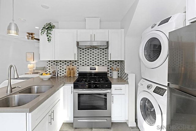 kitchen with white cabinetry, sink, stainless steel range with gas stovetop, and stacked washing maching and dryer