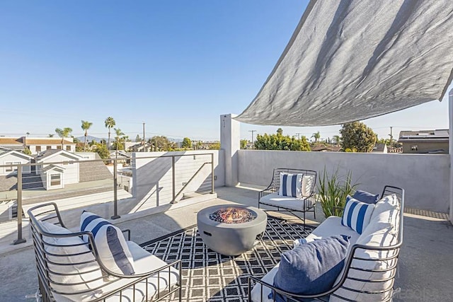 view of patio with an outdoor living space with a fire pit