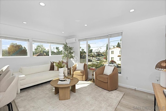 living room featuring an AC wall unit and light hardwood / wood-style flooring