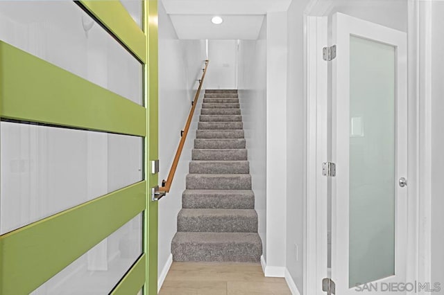 stairs featuring hardwood / wood-style floors