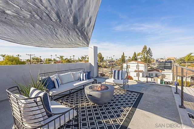 view of patio featuring an outdoor living space with a fire pit