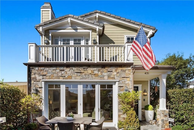 rear view of property with a balcony