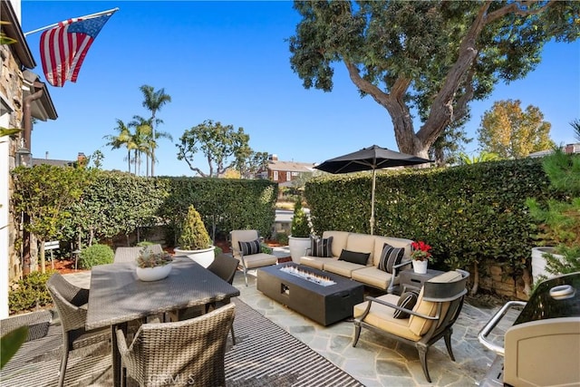 view of patio featuring an outdoor living space with a fire pit