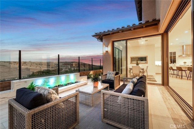 patio terrace at dusk featuring an outdoor hangout area