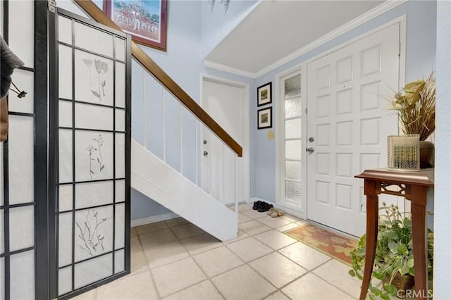 tiled entrance foyer featuring crown molding