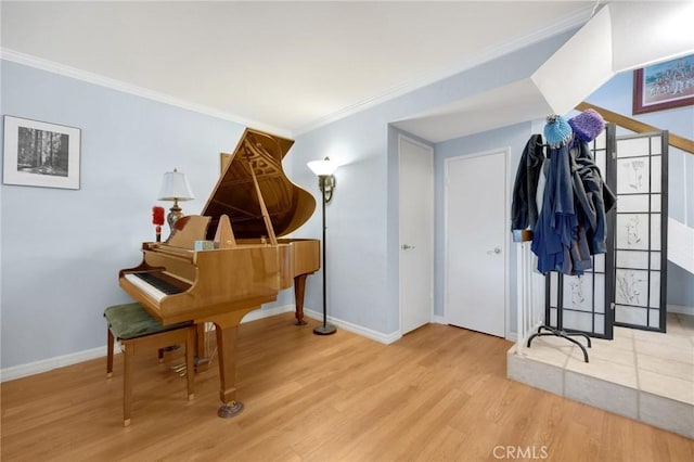 miscellaneous room with light wood-type flooring and ornamental molding