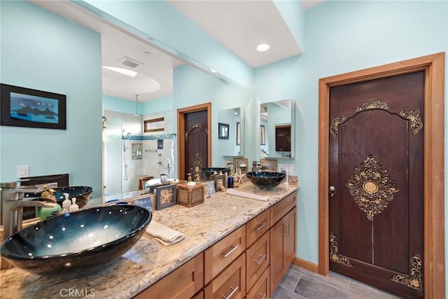 bathroom with vanity and a shower with shower door