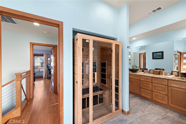 bathroom with vanity and hardwood / wood-style floors