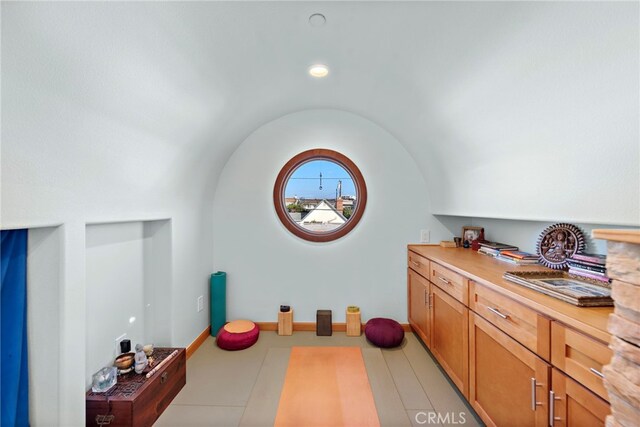 exercise area with lofted ceiling