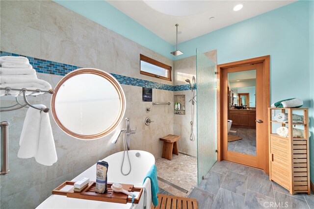 bathroom featuring a tile shower and tile walls