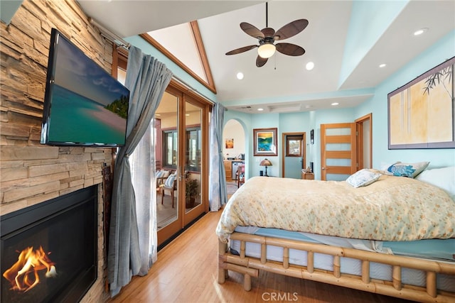 bedroom featuring vaulted ceiling, light hardwood / wood-style floors, and french doors