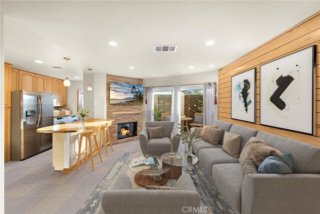 living room featuring a large fireplace