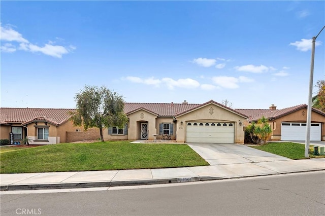 mediterranean / spanish-style home with a front lawn and a garage