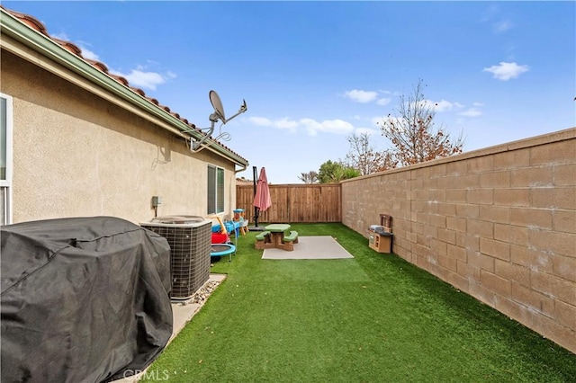 view of yard featuring cooling unit and a patio area