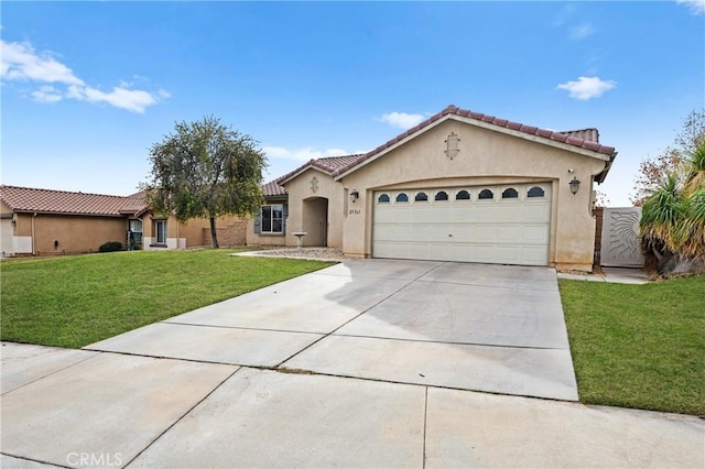 mediterranean / spanish home featuring a garage and a front lawn