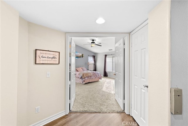 corridor with hardwood / wood-style flooring