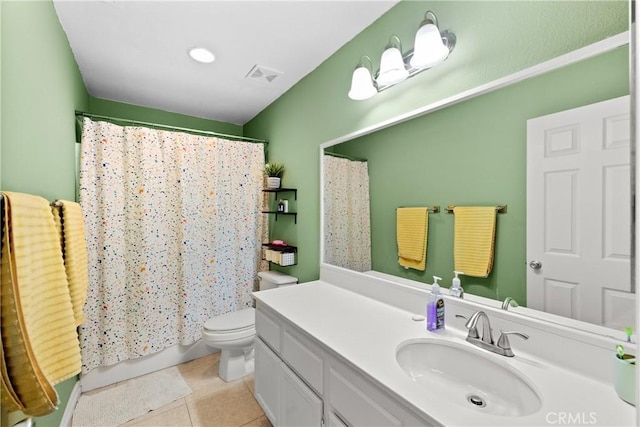 bathroom featuring toilet, vanity, and tile patterned flooring