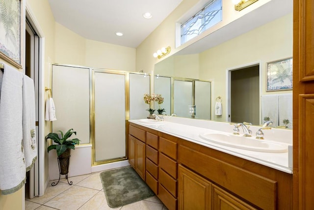 bathroom with an enclosed shower, vanity, and tile patterned flooring