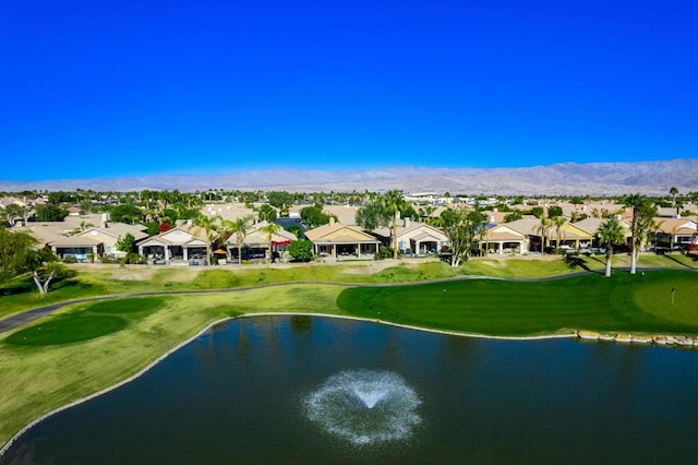 drone / aerial view featuring a water and mountain view