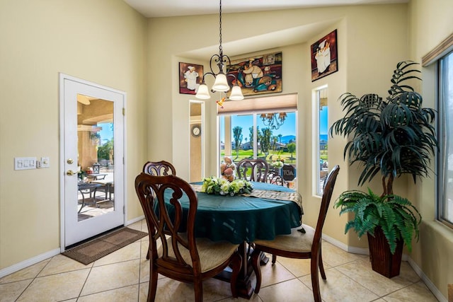 tiled dining room featuring lofted ceiling and a notable chandelier