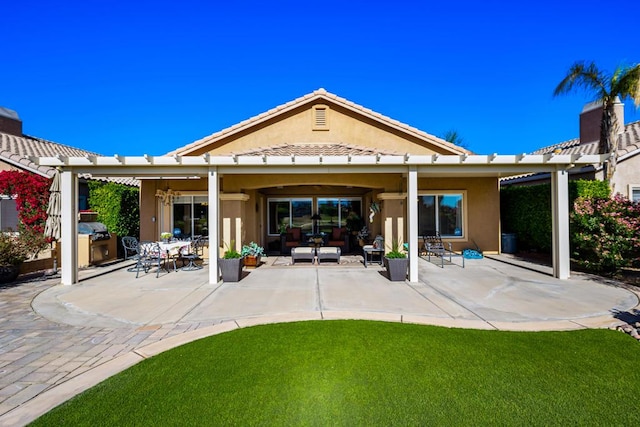 rear view of house with outdoor lounge area, a lawn, and a patio