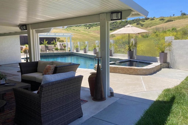 view of pool featuring a patio area, outdoor lounge area, and an in ground hot tub