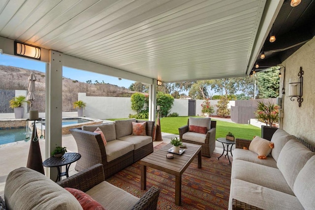 view of patio with an outdoor living space, a mountain view, and a fenced in pool