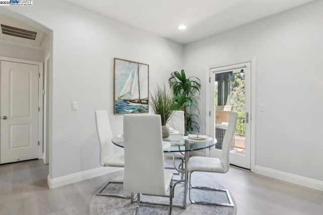 dining space with light hardwood / wood-style floors