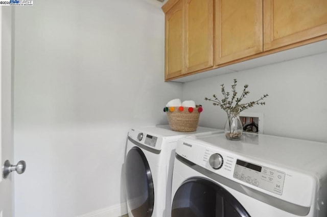 laundry room with cabinets and washer and dryer